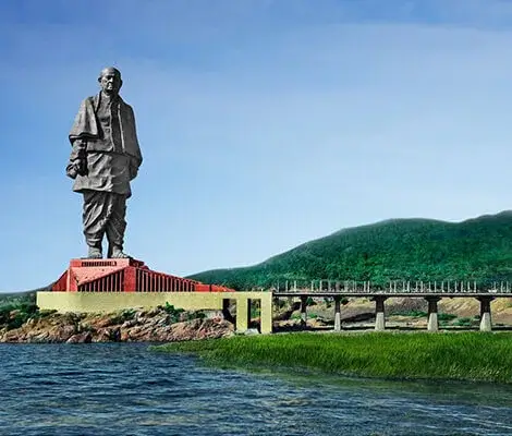 Statue of unity beside a hill next to a bridge